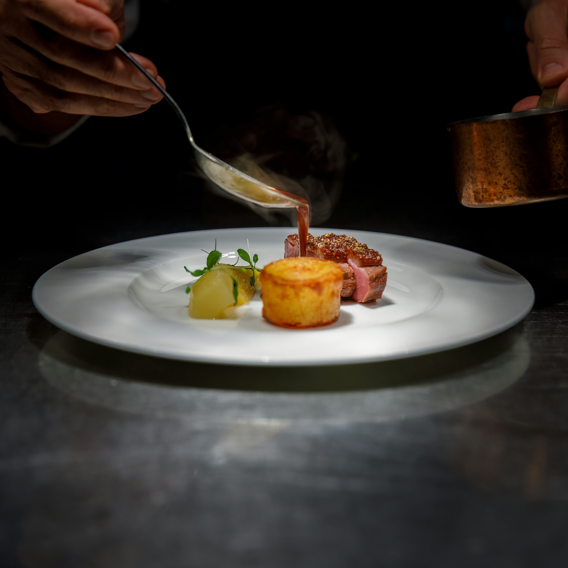 Chef plating a signature dish